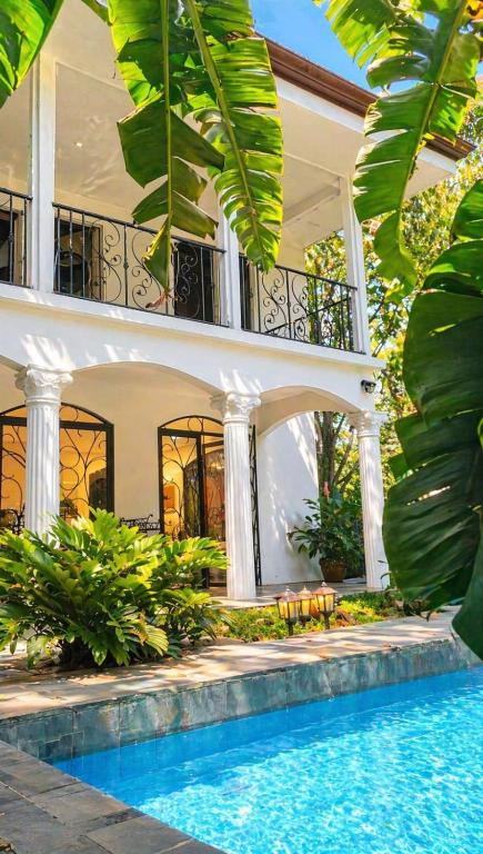 a villa with a swimming pool in front of a house at Villa Sulterra in Tambor