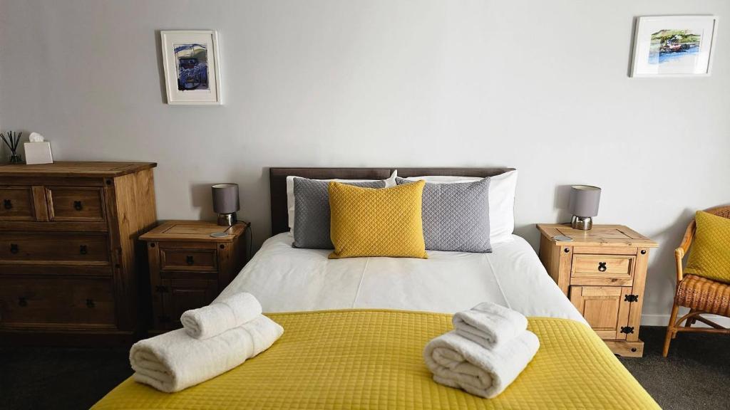 a bedroom with a bed with towels on it at The Old Library in Arisaig