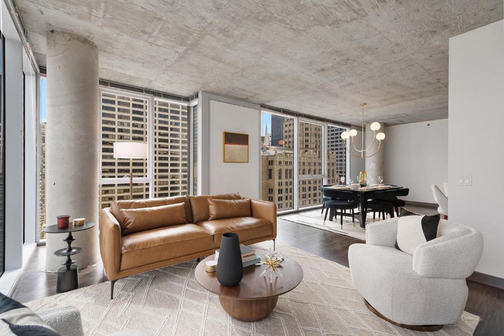 a living room with a couch and a table at Linea Luxury Living with Indoor Pool and Rooftop Views in The Loop in Chicago