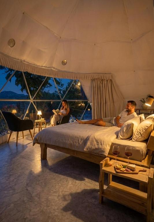 a group of people sitting on a bed in a bedroom at Bubble Glam I Poggetti in Micciano