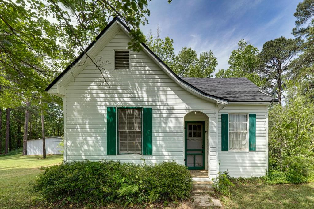 an old white house with green shutters at Private Deck & Yard: Pet-Friendly Noble Getaway in Noble