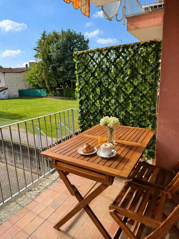 a wooden table and chair on a patio at Ninfa del lago - PRIVATE GARAGE in Colico