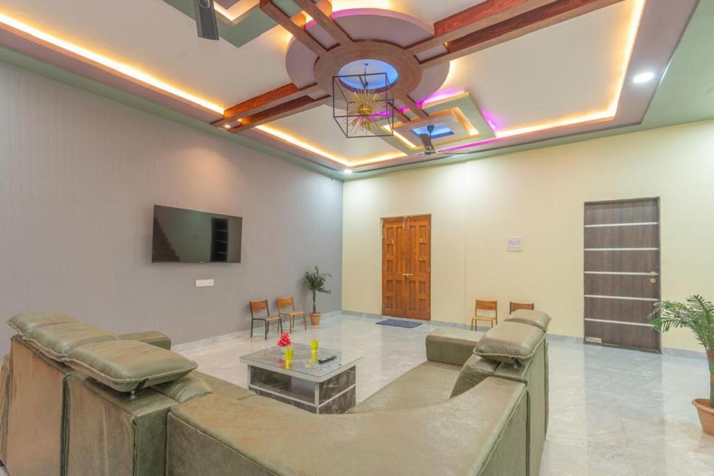 a living room with a couch and a ceiling at Jalsa Bungalow in Malavli
