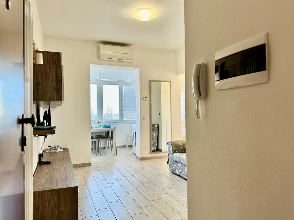 a view of a living room with a couch and a table at 80 Trilocale al Barbara in Lido Adriano