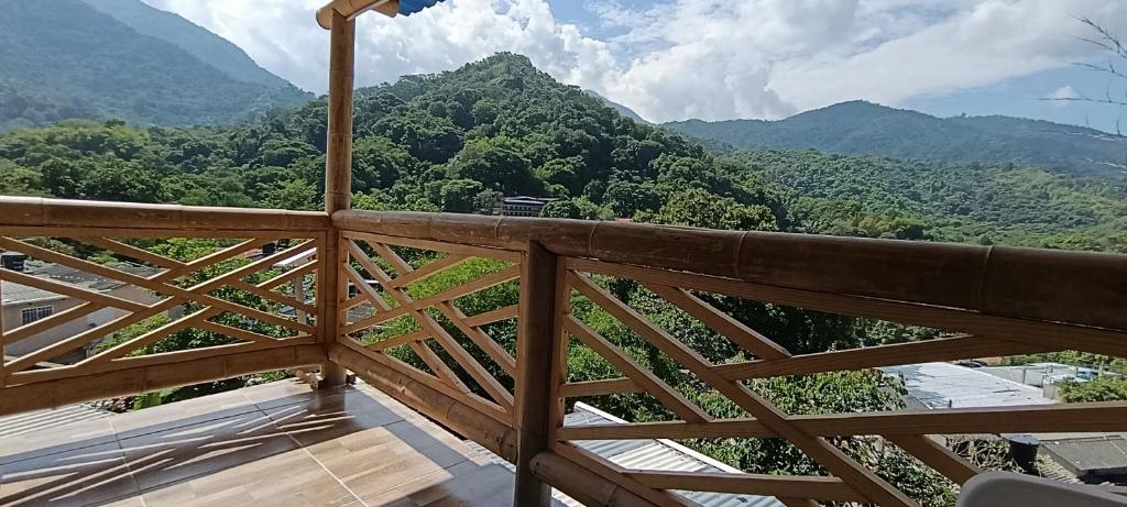 a balcony with a view of the mountains at La Cabañita VIP Amanecer in Minca