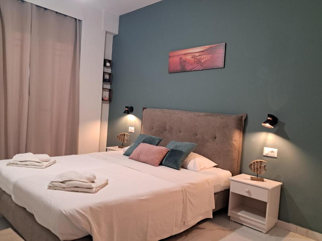 a bedroom with a large bed with white sheets at Poppy Beloni in Chania