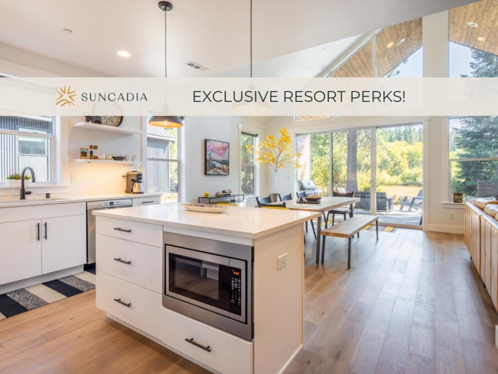 a large kitchen with white cabinets and a dining room at Cabin, Bonus Suite, Suncadia Pool Access in Cle Elum