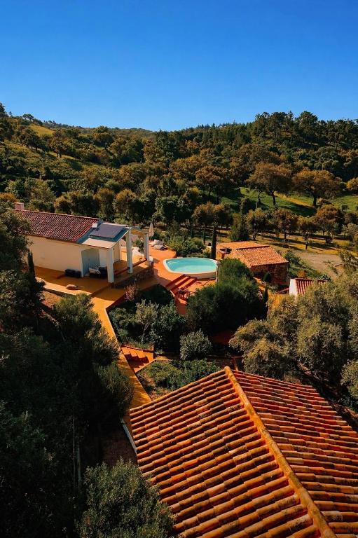 an aerial view of a house with a swimming pool at Monte da Serra de Baixo By CABRA in Sines