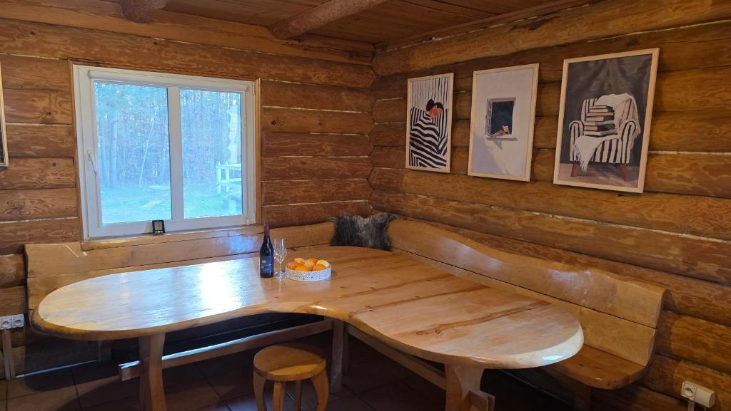 a wooden table in a room with a window at Domek przy stajni in Wielki Głęboczek
