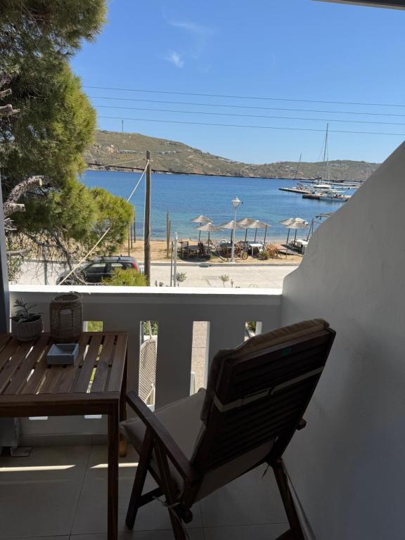 a balcony with a table and a view of a beach at Akti Rooms And Studios in Livadi