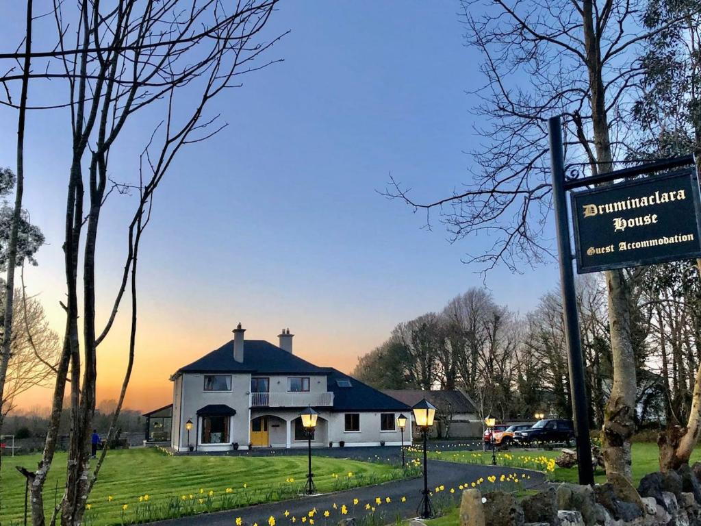 a sign in front of a white house at Guest Suite in County Limerick in Pallaskenry