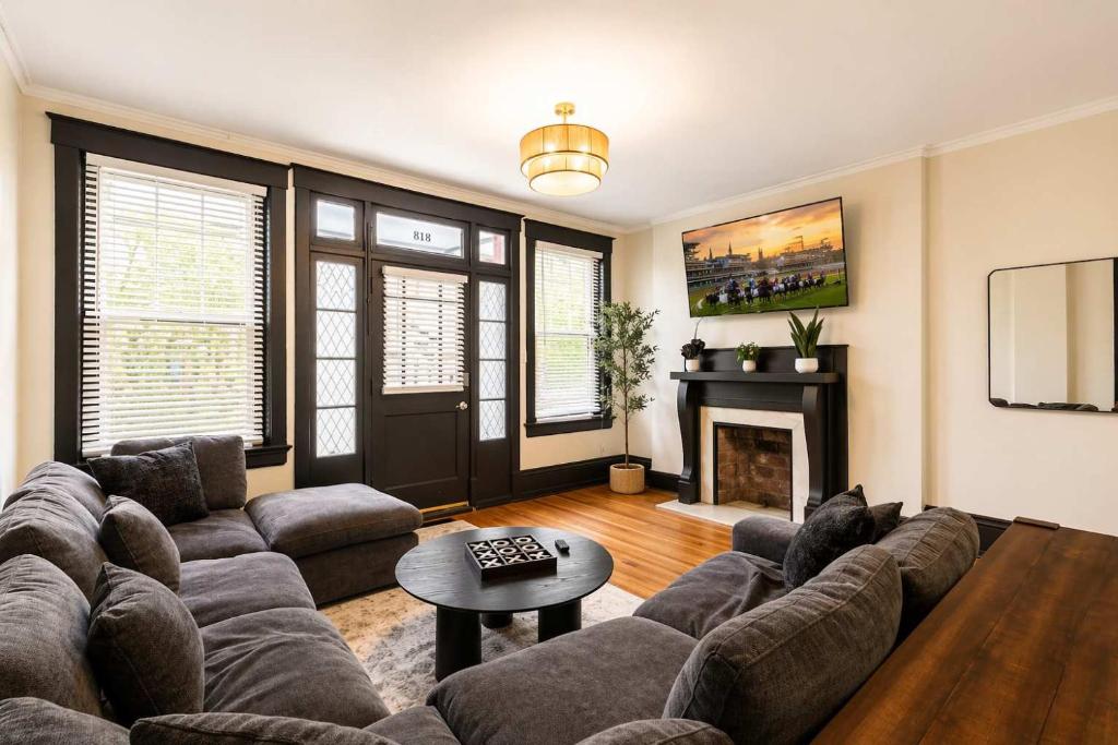 a living room with a couch and a fireplace at Cozy Home near Downtown - Close to Nulu - Sleeps 6 in Louisville