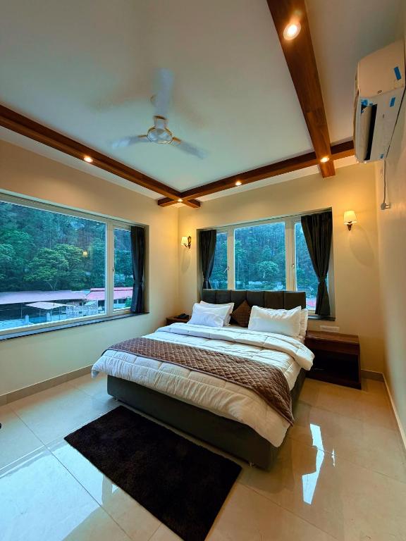 a bedroom with a large bed with a large window at Kesari Hotel & Restaurant Near Kainchi Dham in Rāmgarh
