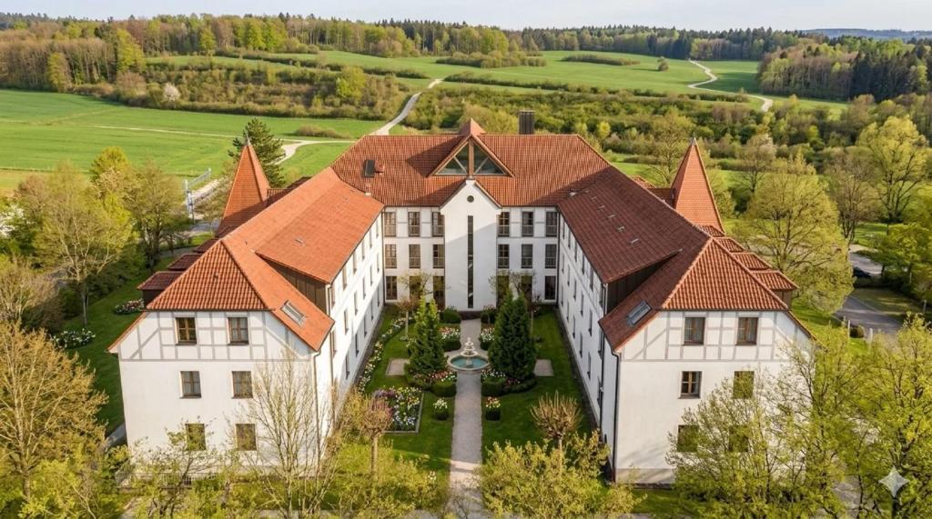 an aerial view of a large white house with a brown roof at Hotel zur Lichtenburg in Ostheim