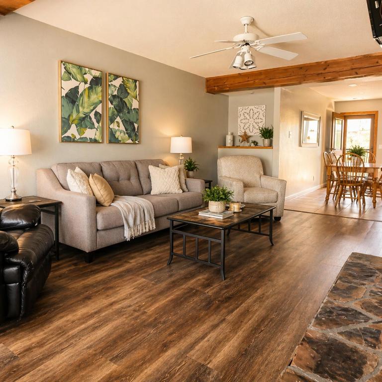 a living room with a couch and a table at The Calm Cove - Near shopping and entertainment in Osage Beach