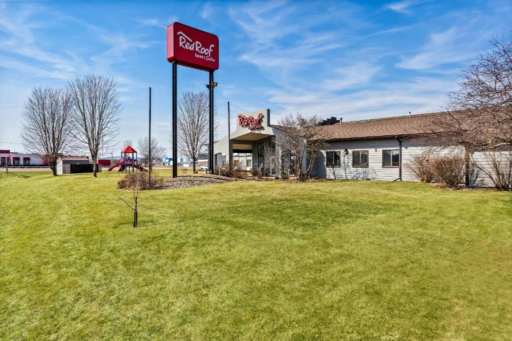 a sign for a cocacola restaurant in a field at Red Roof Inn & Suites Tomah in Tomah