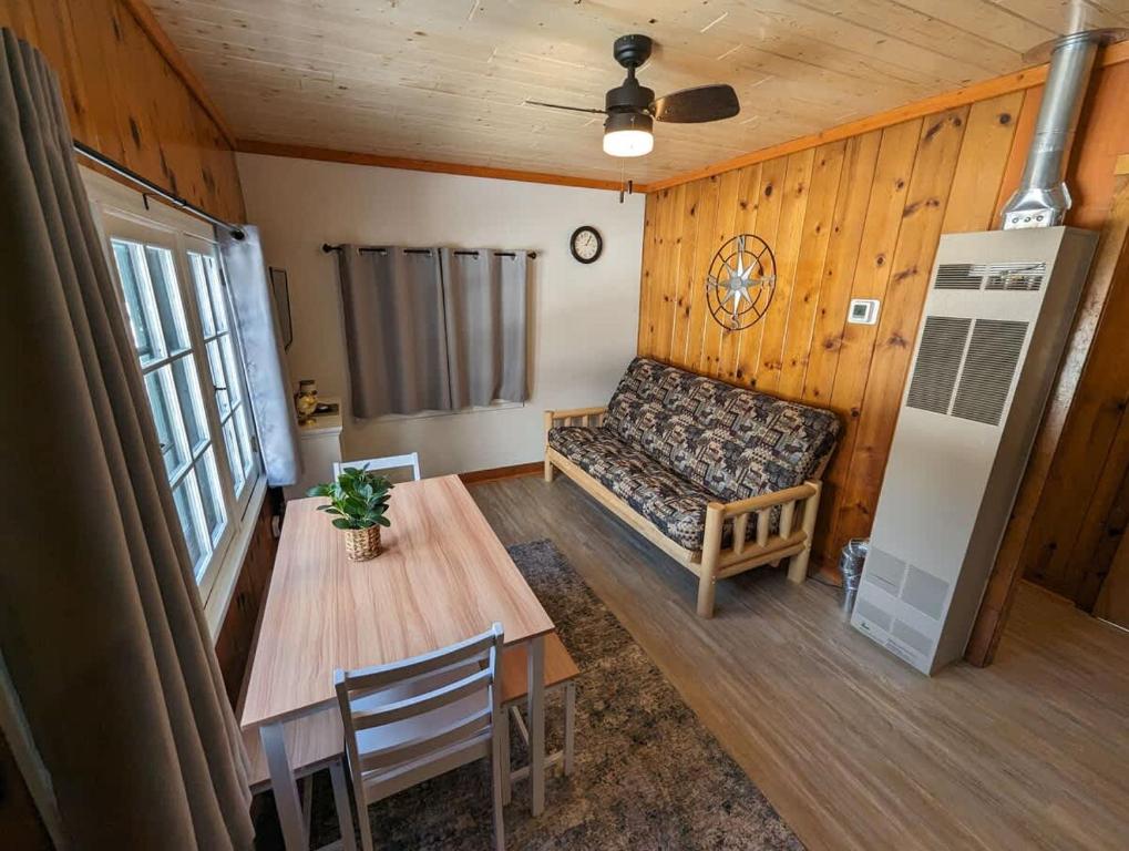 a living room with a couch and a table at 2BR 1BA Cabin #3 Riverside Point Resort in Park Rapids