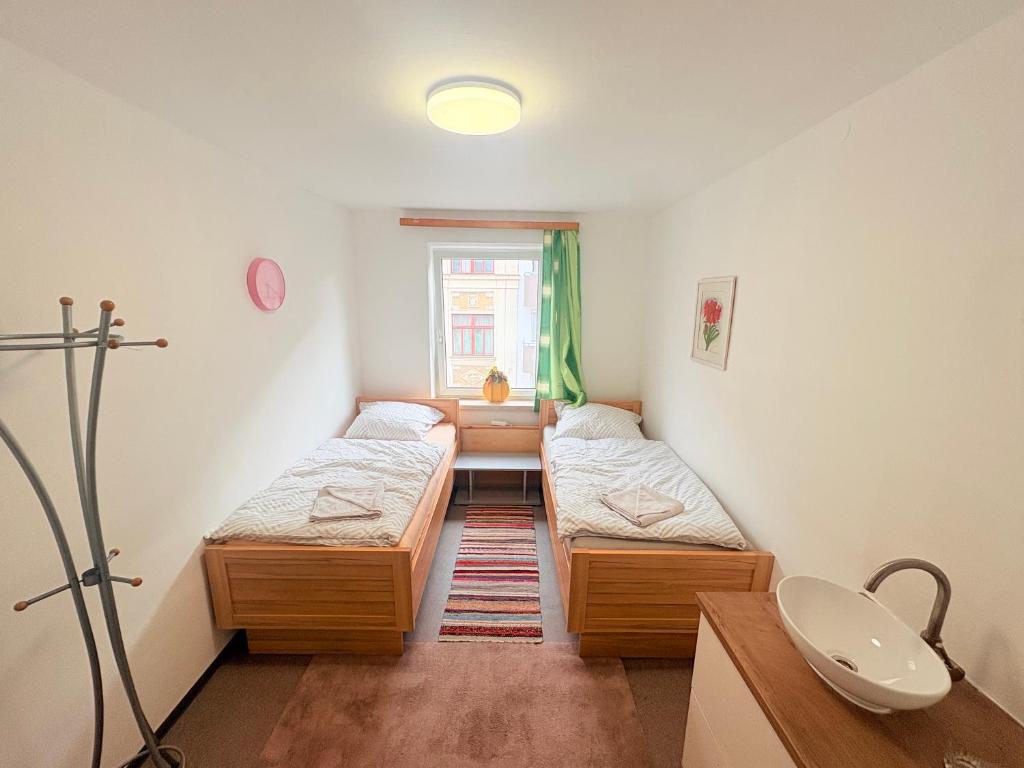 a small room with two beds and a sink at Beenie 3 in Linz