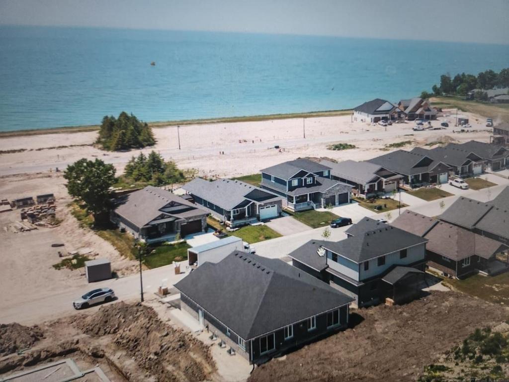 an aerial view of a beach with houses and the ocean at Prettiest town's lake- Bungalow in Goderich