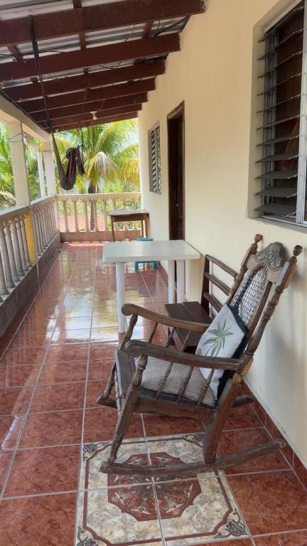 a bench sitting on the porch of a house at Accommodation in Copán Ruinas #7 in Copán Ruinas