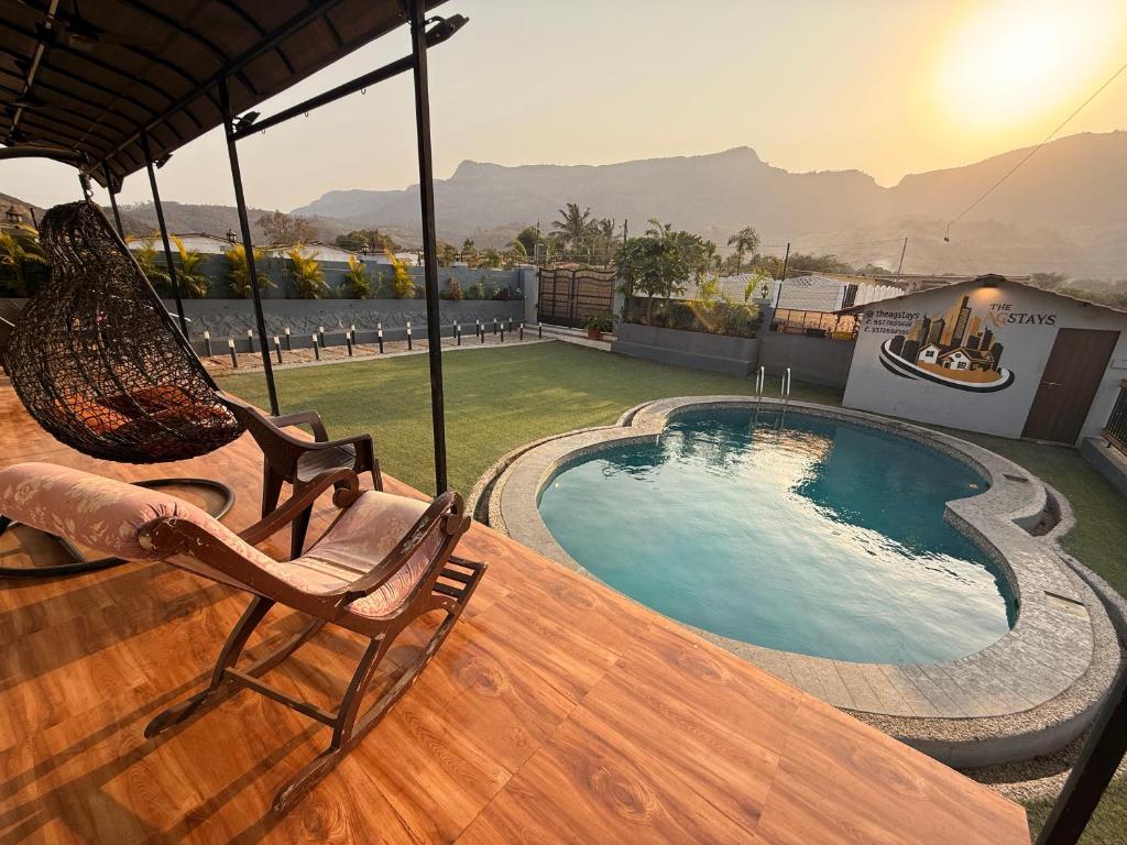 a deck with chairs and a swimming pool on a house at AG ViLLA NERAL in Neral