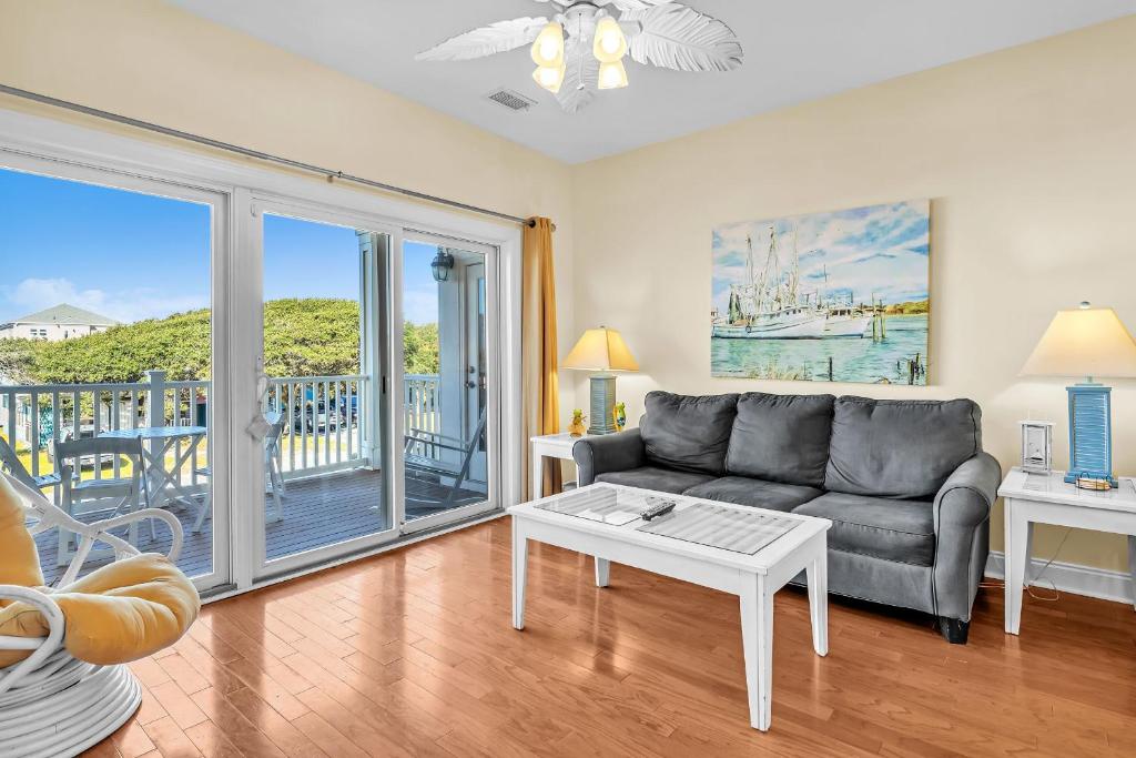 a living room with a couch and a table at The Dunes by Oak Island Accommodations in Oak Island
