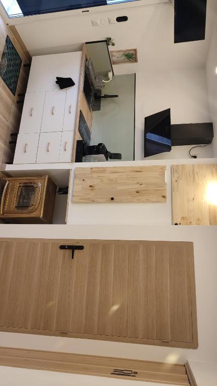 a room with wooden cabinets and a mirror at logement indépendant proche des plages in Aimargues