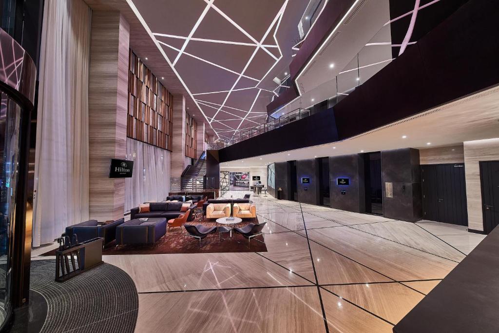 a lobby with couches and chairs in a building at Hilton Belgrade in Belgrade
