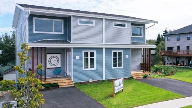 a blue house with a clock on the front of it at Private Spacious Walkout Suite Near Downtown in Halifax