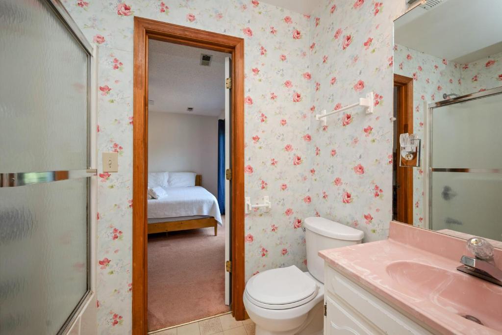 a bathroom with a toilet and a sink at The Rectory by Oak Island Accommodations in Oak Island