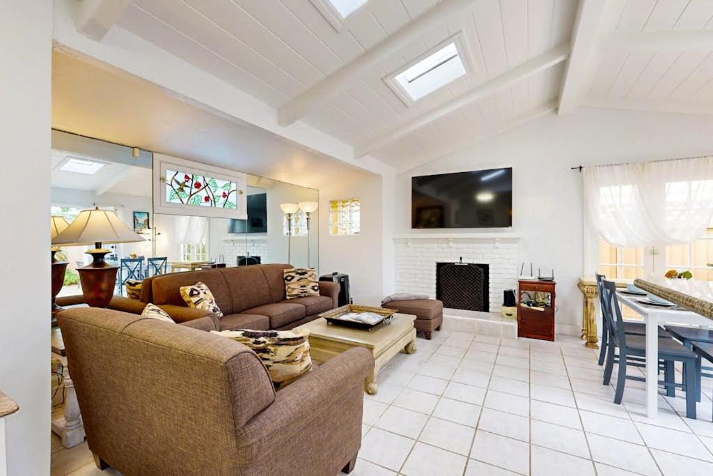 a living room with two couches and a fireplace at Relaxation Station in Corona del Mar