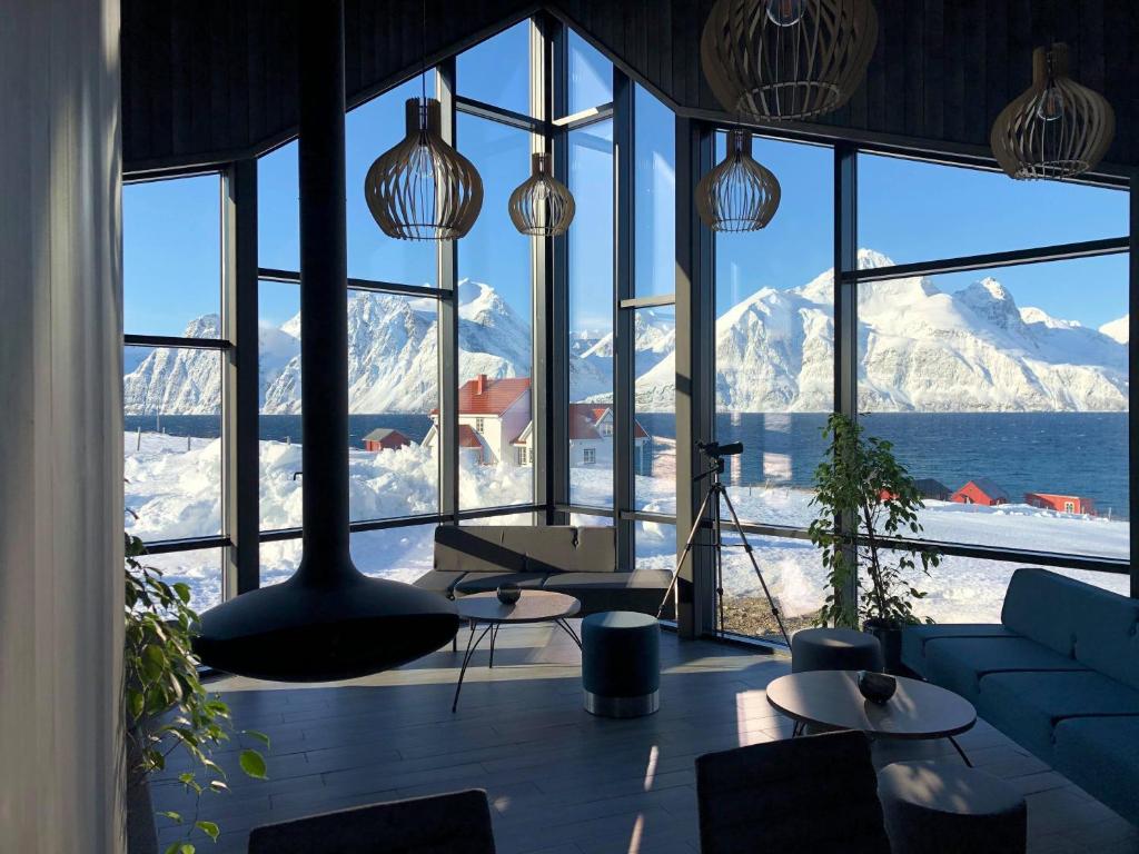 a living room with a view of a mountain at Lyngen North in Rotsund