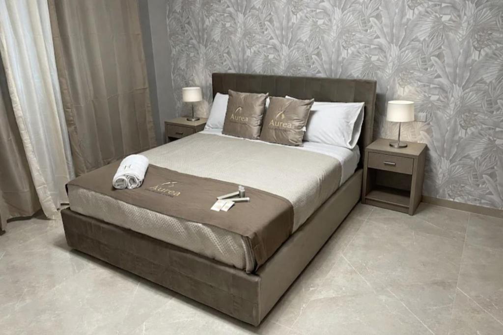 a bedroom with a bed with a phone on it at Aurea Boutique Rooms in Termoli