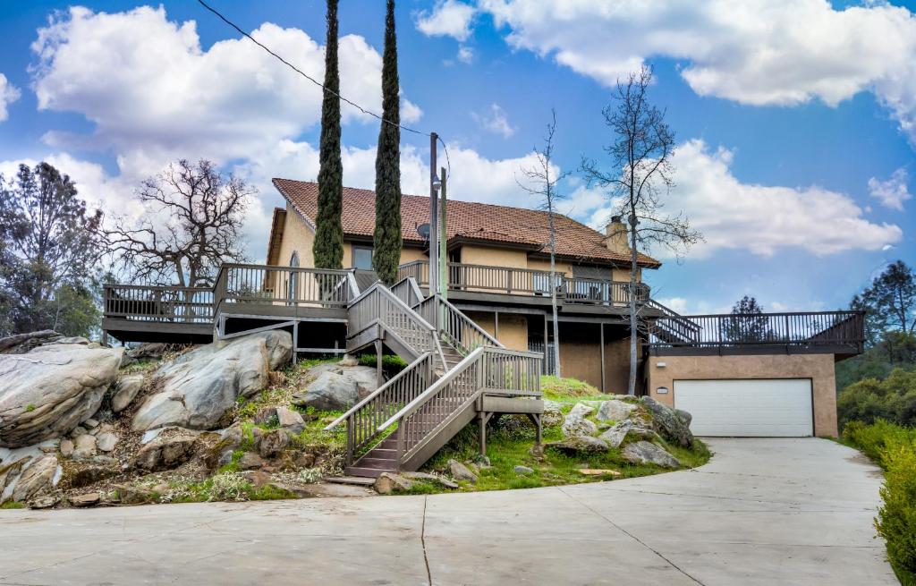 a house on top of a hill with a garage at Mountain Hideway in Coarsegold