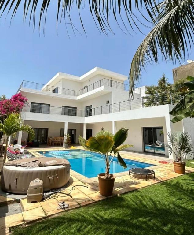 a large white house with a swimming pool at Paradise View Villas in Malindi