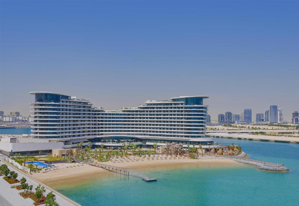 a hotel with a beach and a large building at Waldorf Astoria Doha Lusail in Doha