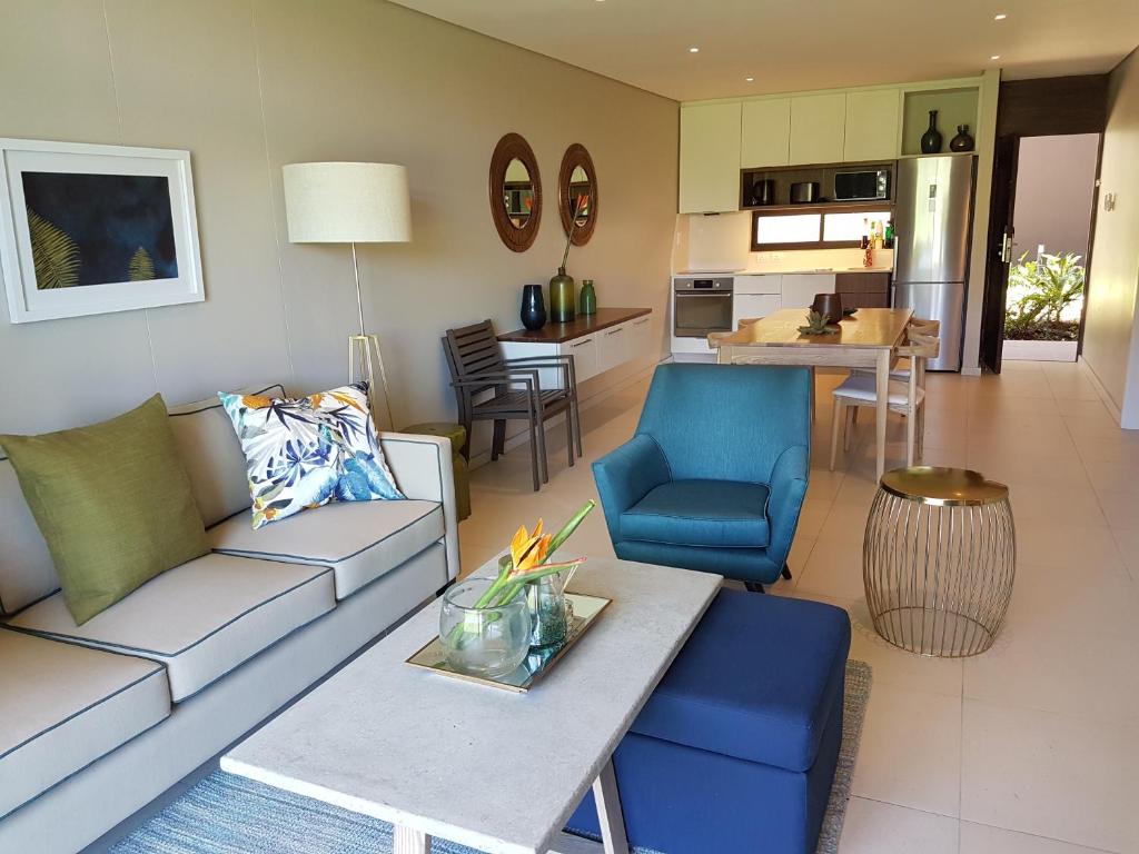 a living room with a couch and a table at Zimbali Suites 110 in Ballito