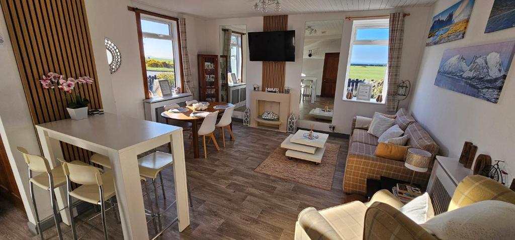 a living room with a couch and a dining room at Westview in Buckie