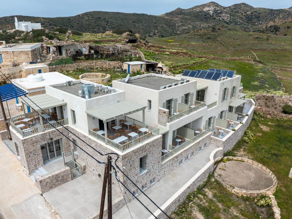 an aerial view of a house with solar panels on it at Onar Hotel Kimolos in Kimolos
