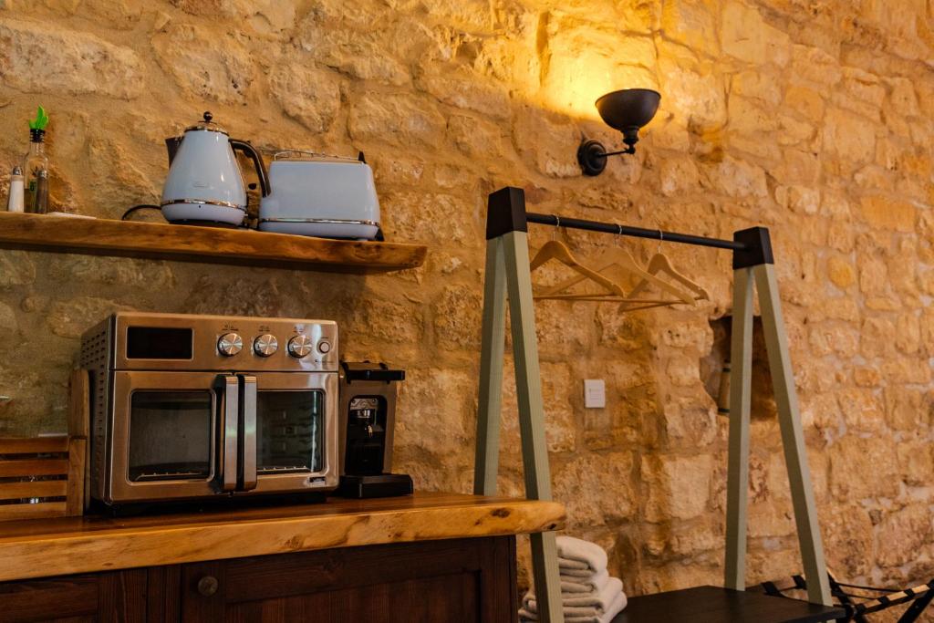 a microwave sitting on top of a counter with a light at Talbot House by Talbot & Bons in Luqa