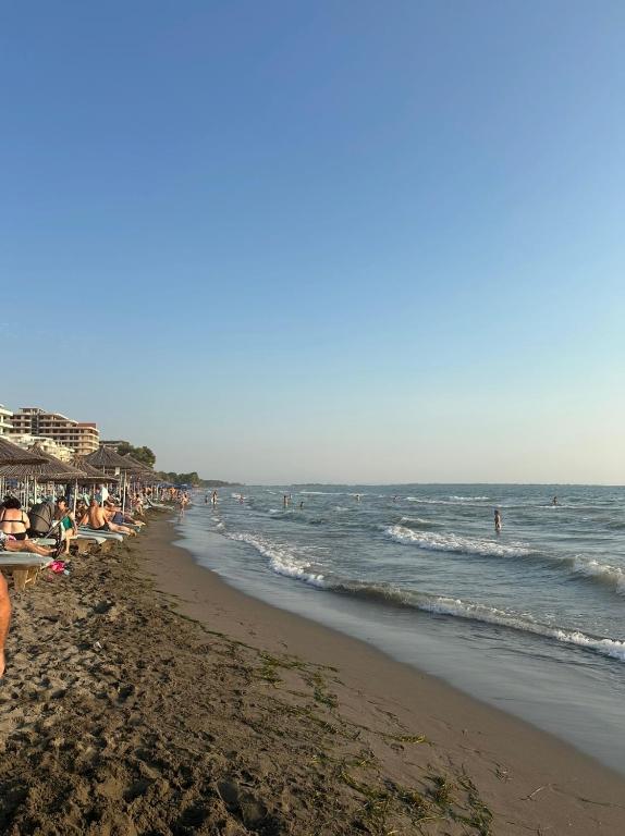 a beach with a lot of people and the ocean at Shengjin in Lezhë
