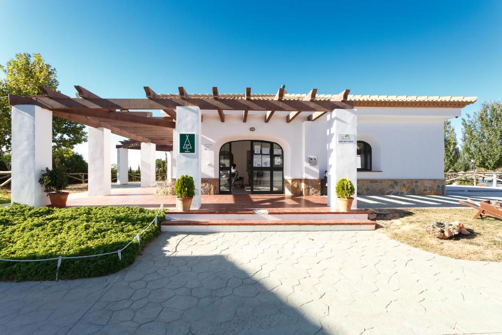 a villa with a entrance to a building at Camping la Sierrecilla in Humilladero