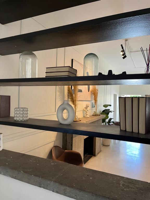 a shelf with vases and other items on it at Jazz & Stay in Guadalajara