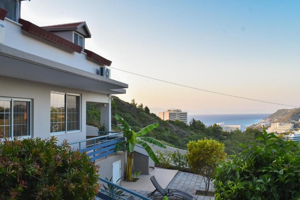 a house with a balcony with a view of the ocean at Monte Mare Rhodes in Ixia