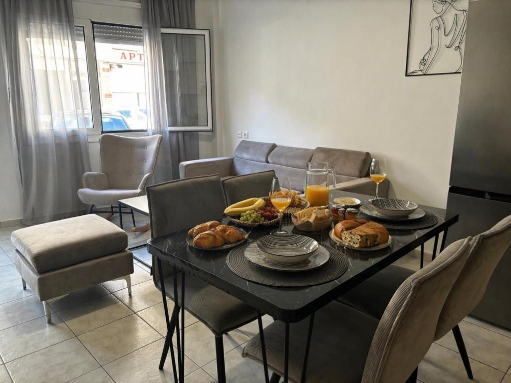 a table with food on it in a living room at Emari Apartments in Heraklio