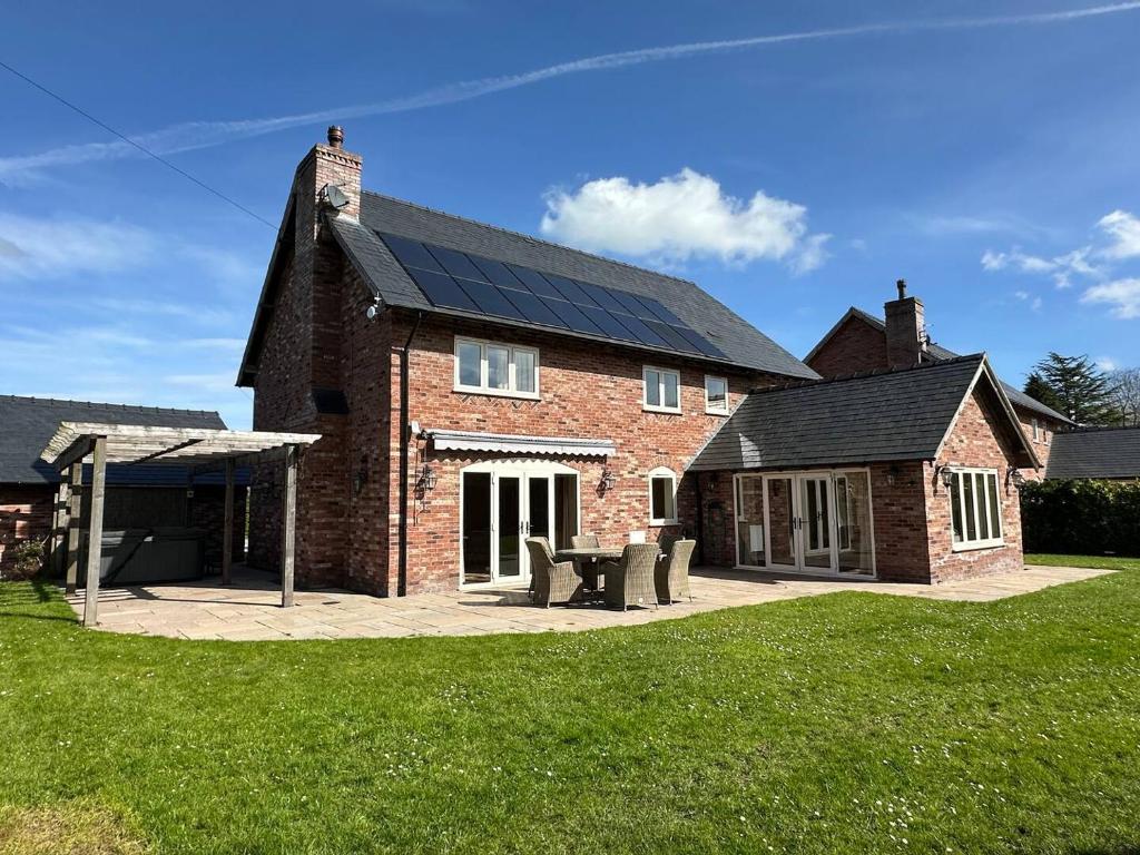 a house with solar panels on the roof at Stocks Lane Cottage in Welshampton