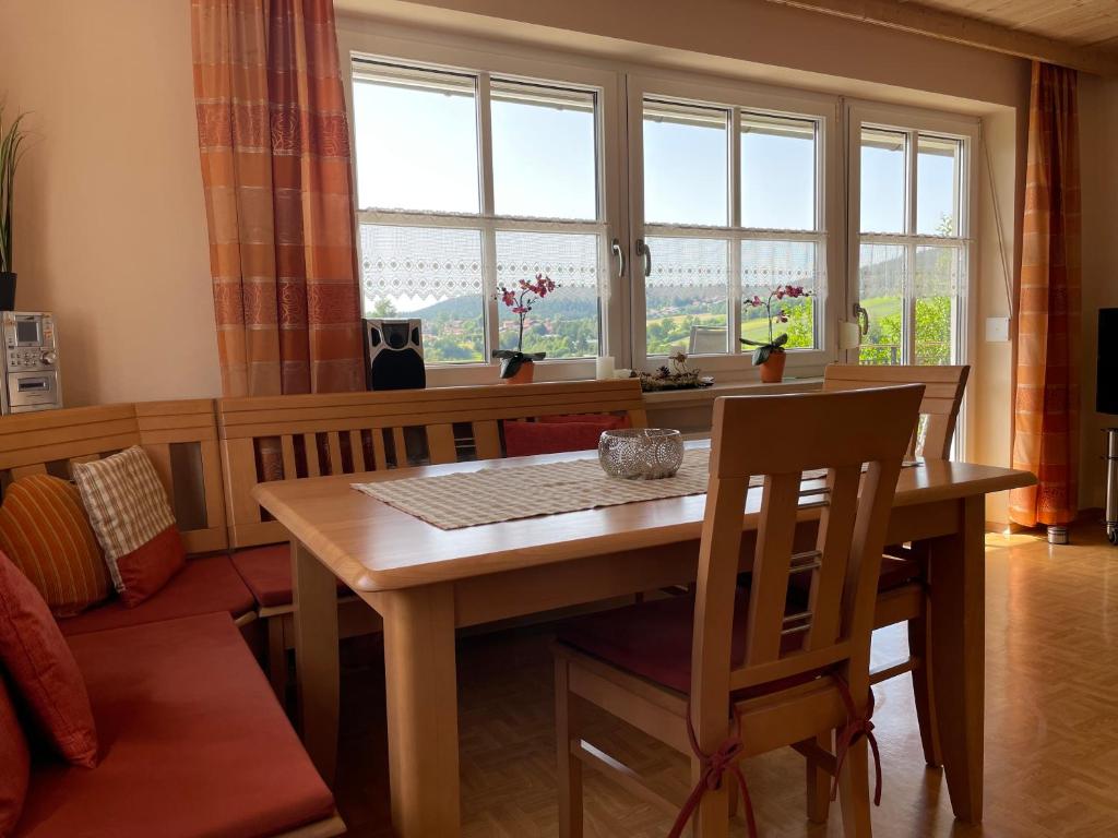 a dining room with a table and chairs and a window at Ferienhaus Heidi in Lam