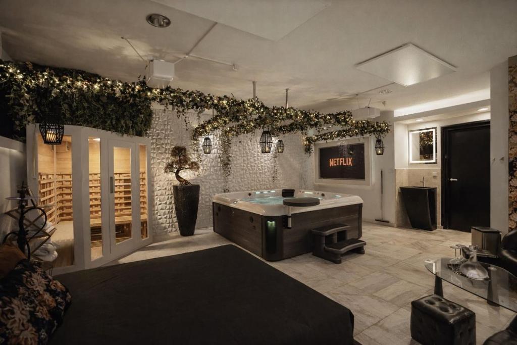 a room with a tub in the middle of a room at B&W Malina Jacuzzi Suite in Lelystad