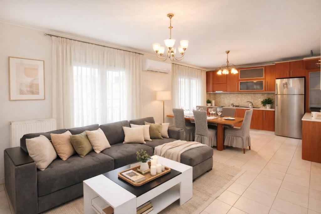 a living room with a couch and a table at Epanomi Family Apartments in Epanomi
