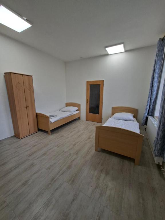 a room with two beds and two cabinets in it at Byt v okresu Děčin in Dolní Habartice
